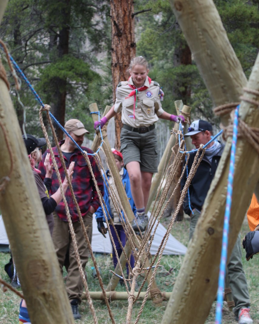 Troop 114G monkey bridge / rope bridge construction with girl scout walking across